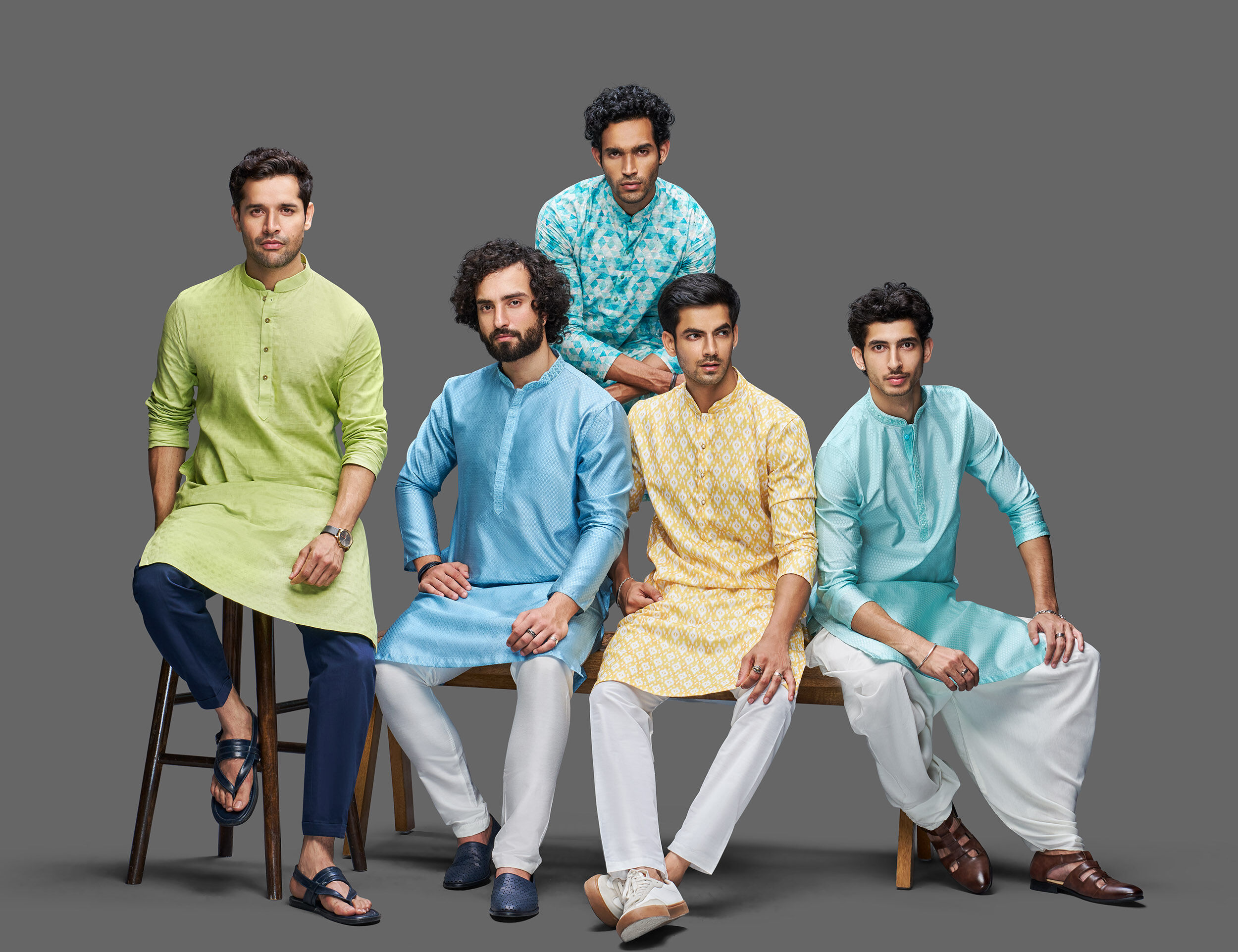Men wearing handcrafted kurtas in natural tones celebrate sustainable fashion through timeless design.
